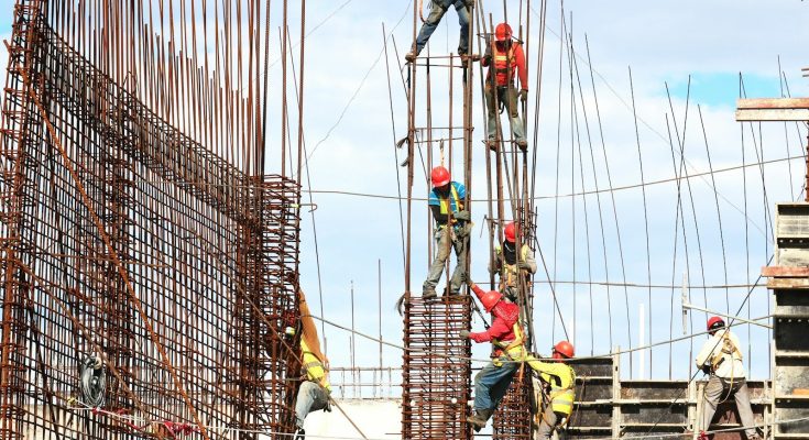 people working on building during daytime